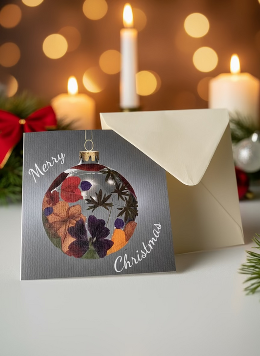 Christmas card with floral ornament design and envelope on a light surface